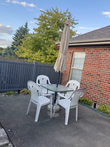 a view of a patio with a table and chairs