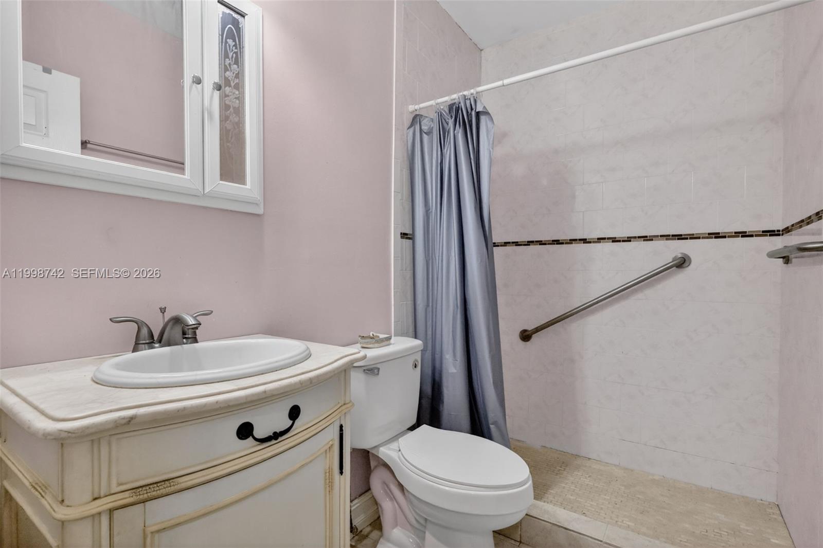 733 West 33rd Street Hialeah, FL 33012 - Photo 14 of 45 a bathroom with a sink toilet vanity and shower