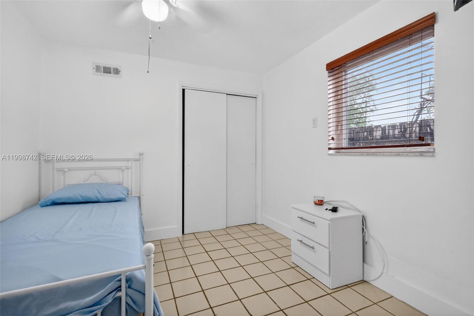 733 West 33rd Street Hialeah, FL 33012 - Photo 16 of 45 a bedroom with a bed and a table in it