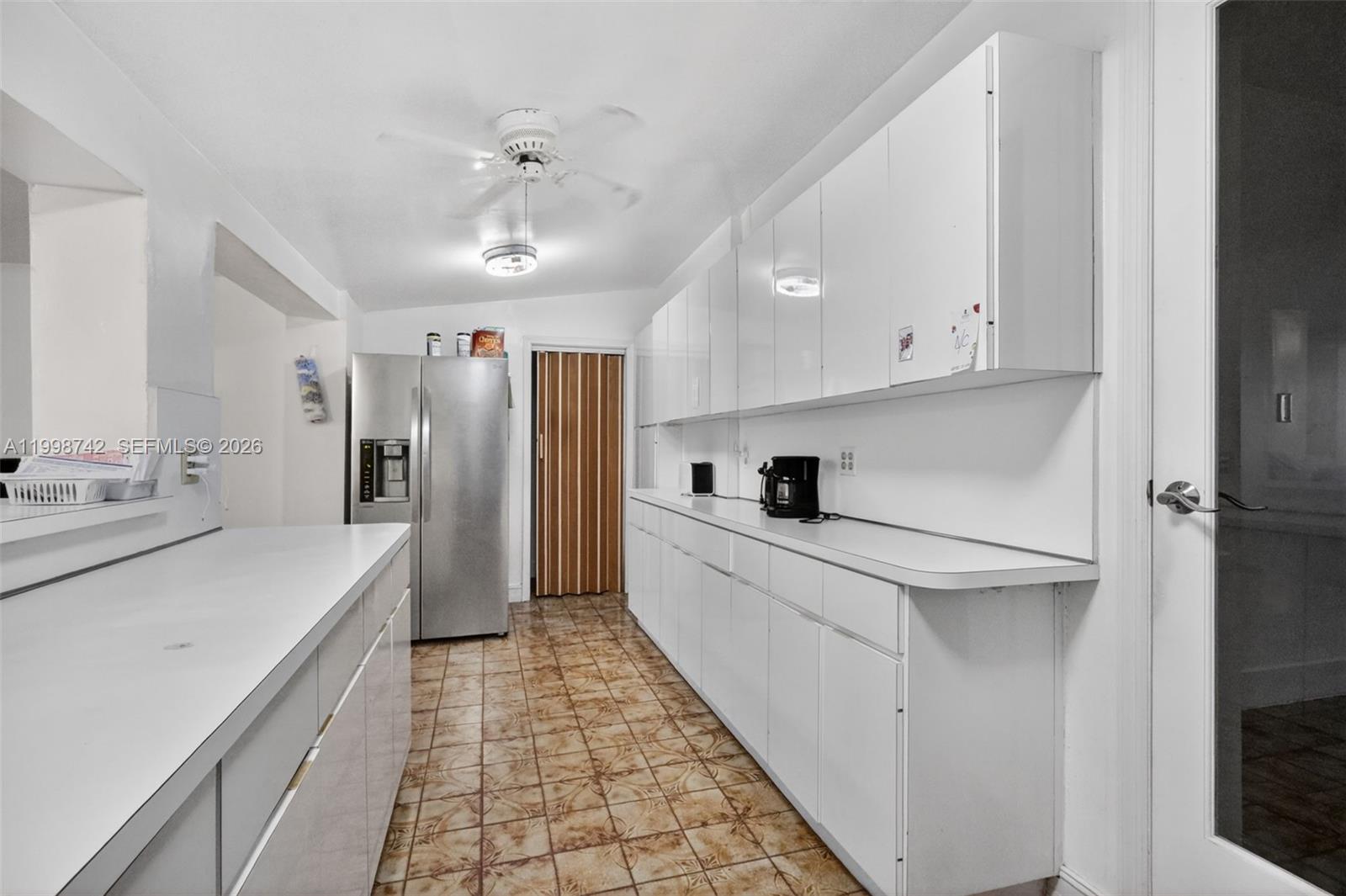 733 West 33rd Street Hialeah, FL 33012 - Photo 20 of 45 a kitchen with stainless steel appliances a refrigerator sink and cabinets
