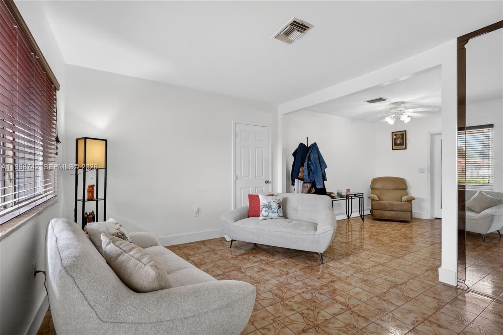 733 West 33rd Street Hialeah, FL 33012 - Photo 2 of 45 a living room with furniture and a wooden floor