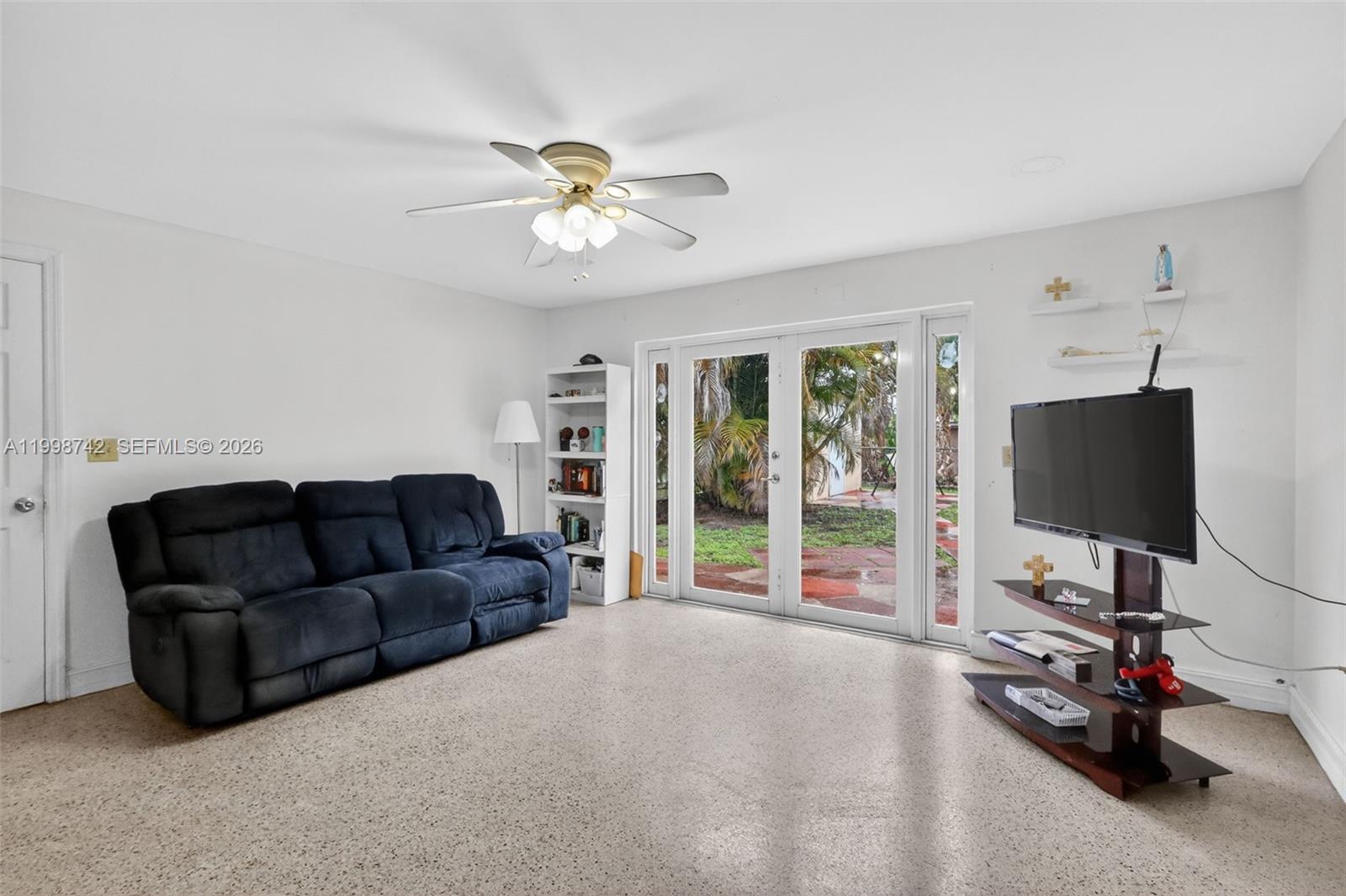 733 West 33rd Street Hialeah, FL 33012 - Photo 27 of 45 a living room with furniture a flat screen tv and a large window