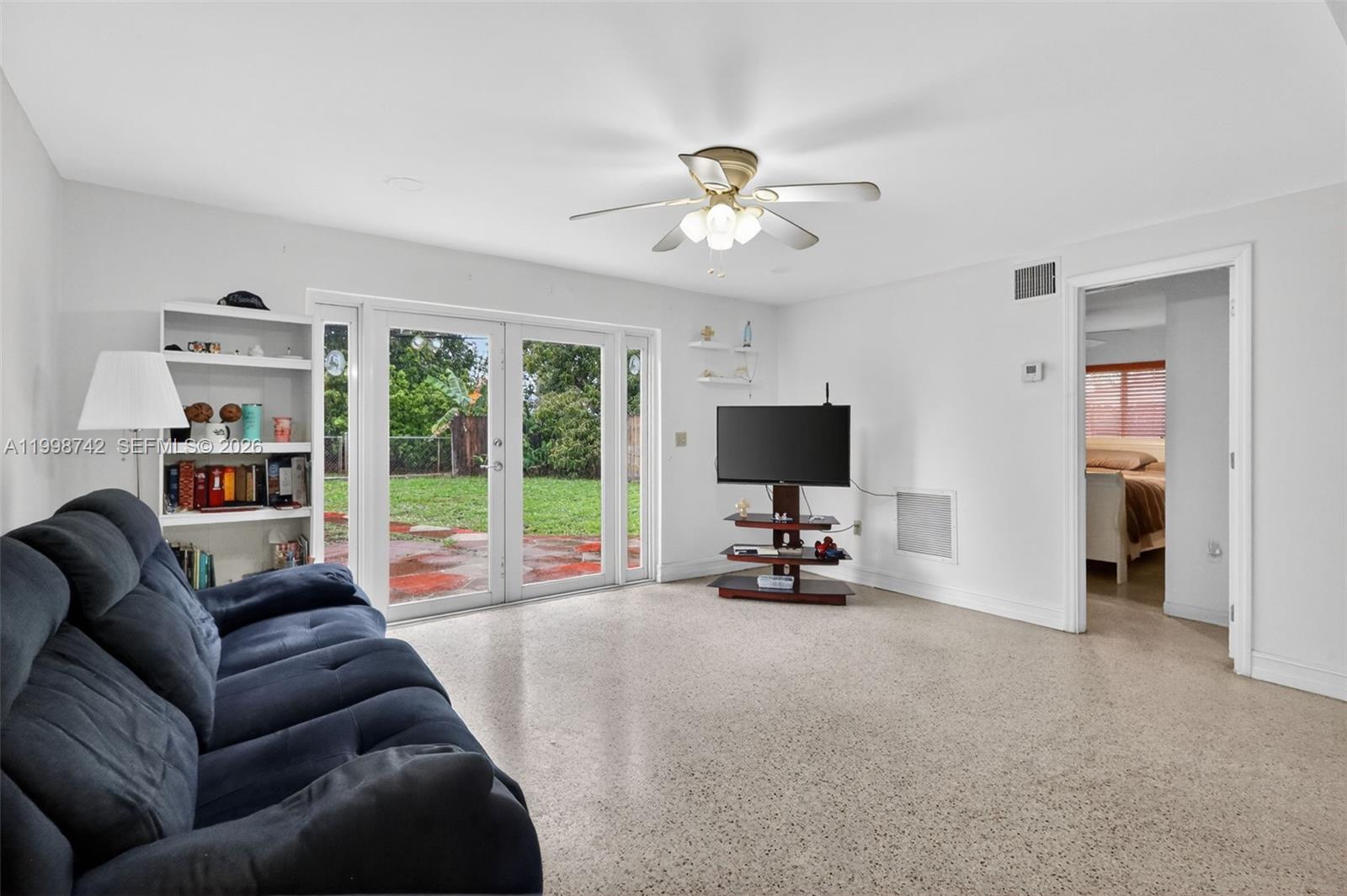 733 West 33rd Street Hialeah, FL 33012 - Photo 28 of 45 a living room with furniture a flat screen tv and a large window