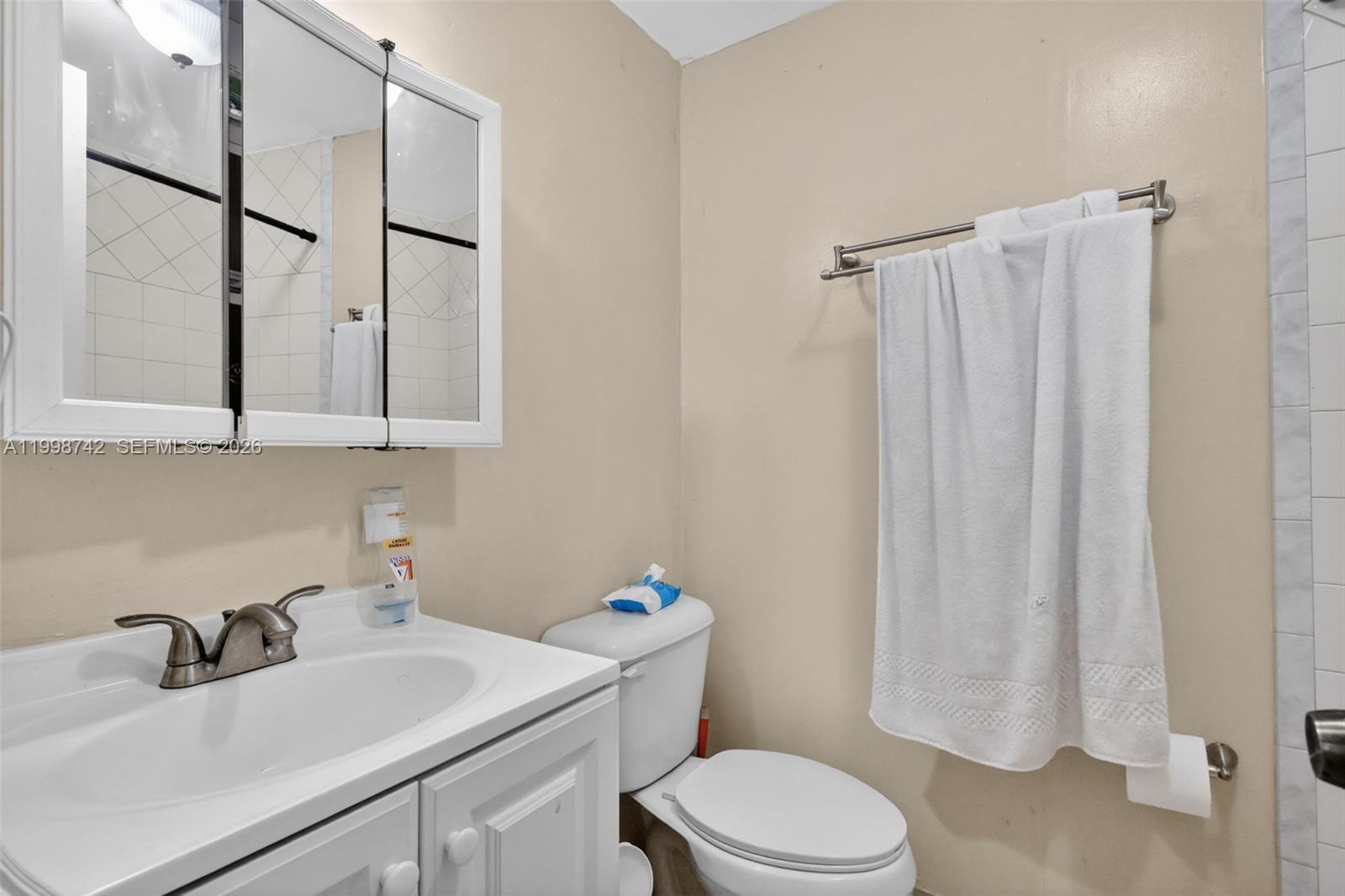 733 West 33rd Street Hialeah, FL 33012 - Photo 34 of 45 a bathroom with a sink a toilet and shower curtain