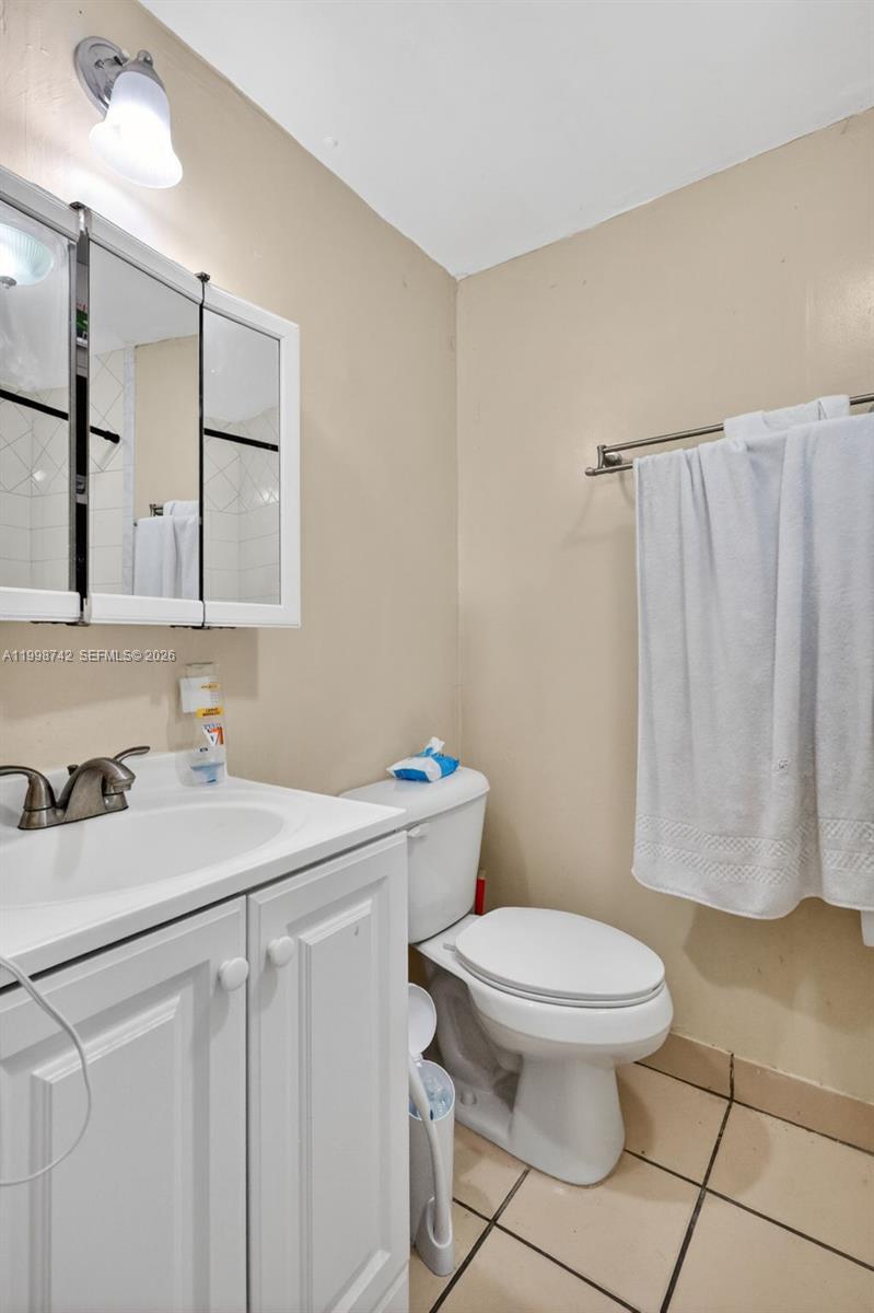 733 West 33rd Street Hialeah, FL 33012 - Photo 35 of 45 a bathroom with a sink a toilet and a mirror