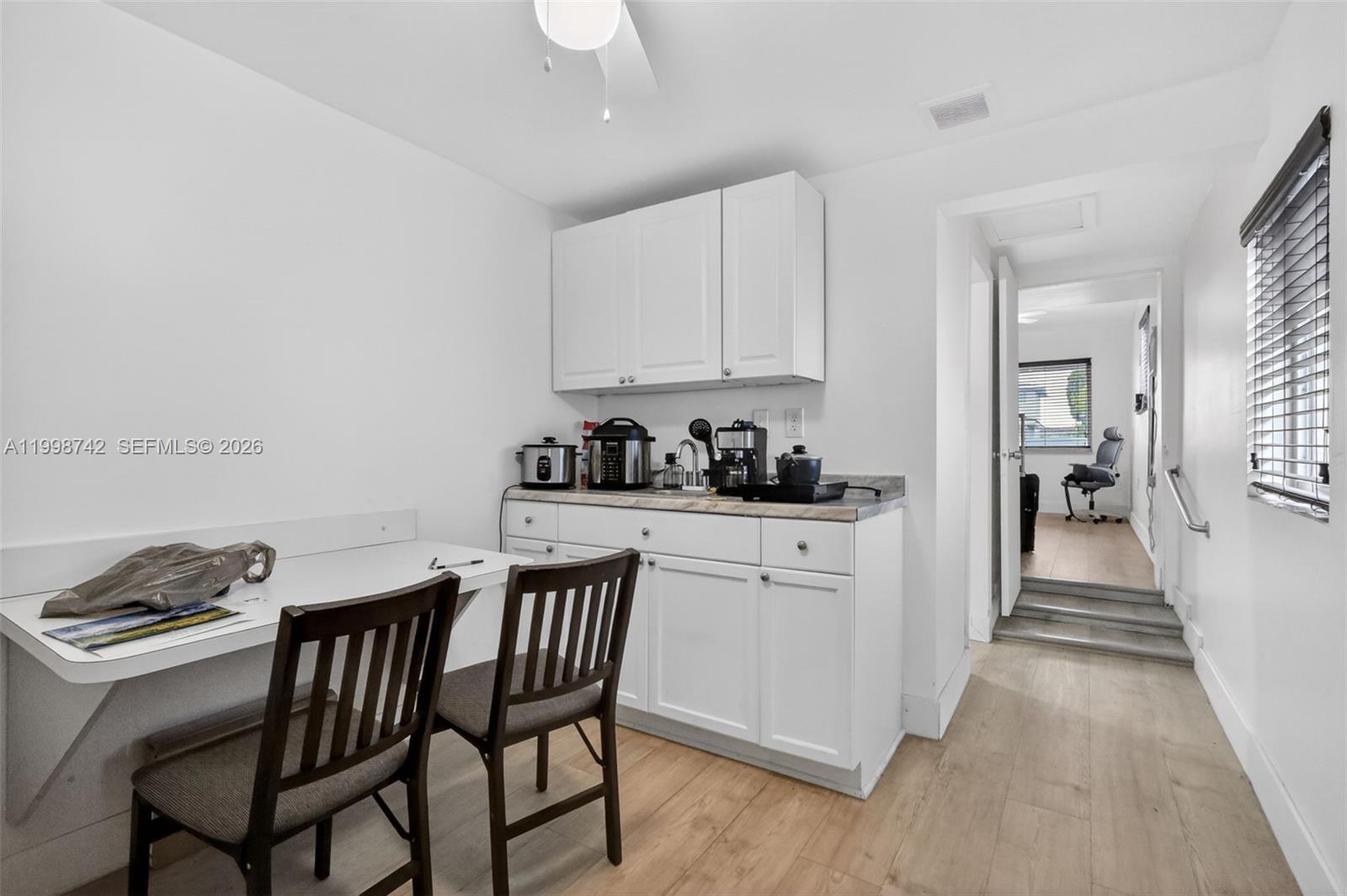 733 West 33rd Street Hialeah, FL 33012 - Photo 39 of 45 a kitchen with stainless steel appliances granite countertop a white cabinets and a stove top oven