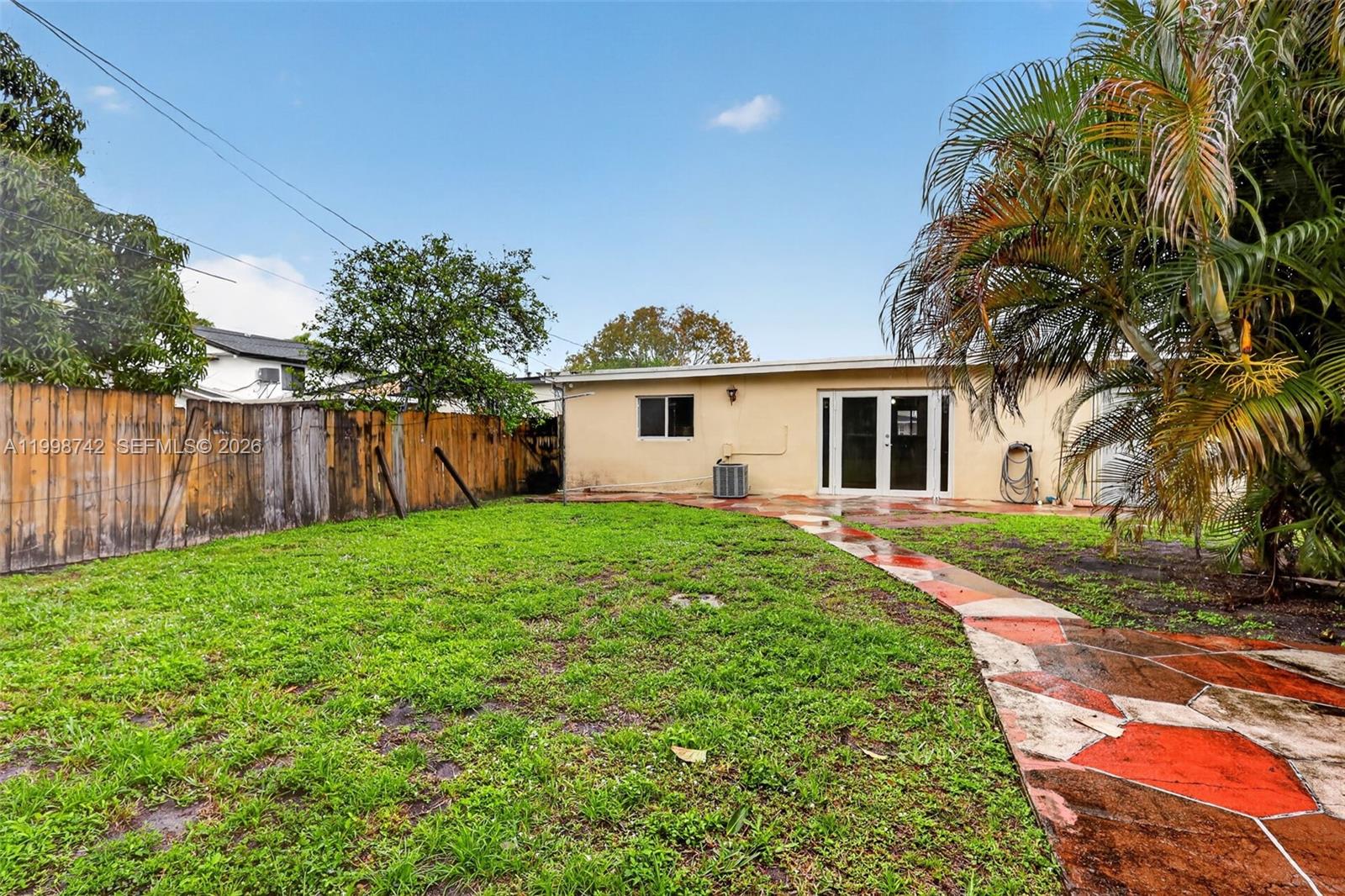 733 West 33rd Street Hialeah, FL 33012 - Photo 43 of 45 a view of a house with backyard and a tree