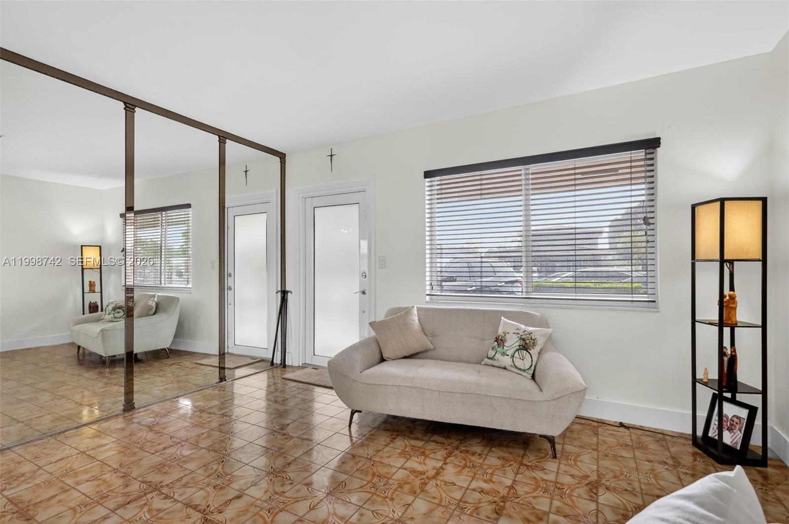 733 West 33rd Street Hialeah, FL 33012 - Photo 5 of 45 a living room with furniture and a window