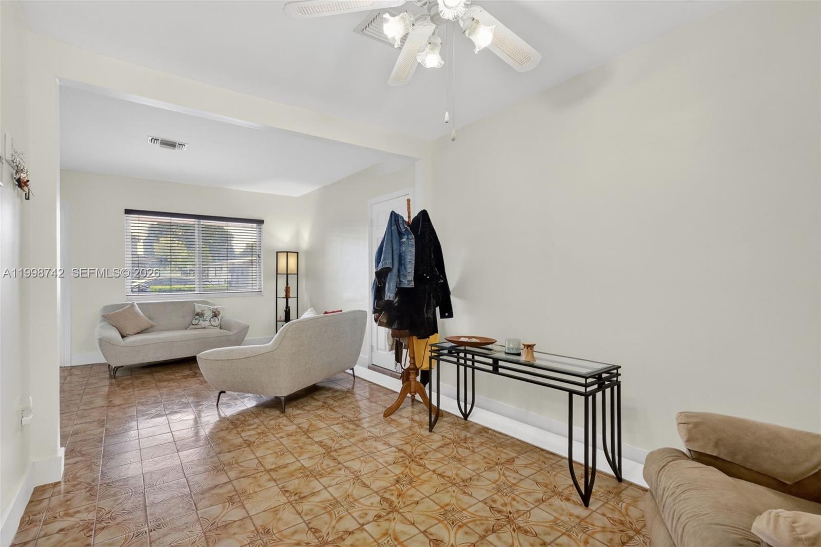 733 West 33rd Street Hialeah, FL 33012 - Photo 7 of 45 a living room with furniture and a flat screen tv