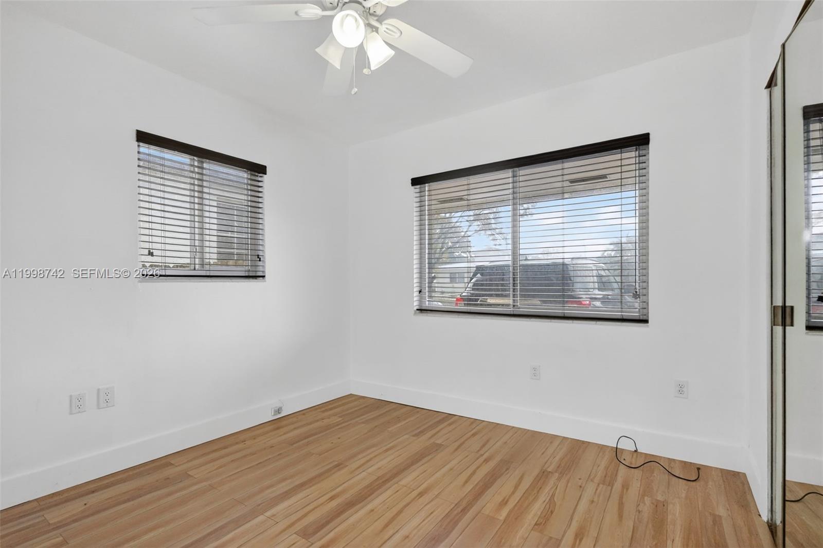 733 West 33rd Street Hialeah, FL 33012 - Photo 8 of 45 a view of an empty room with wooden floor and a window
