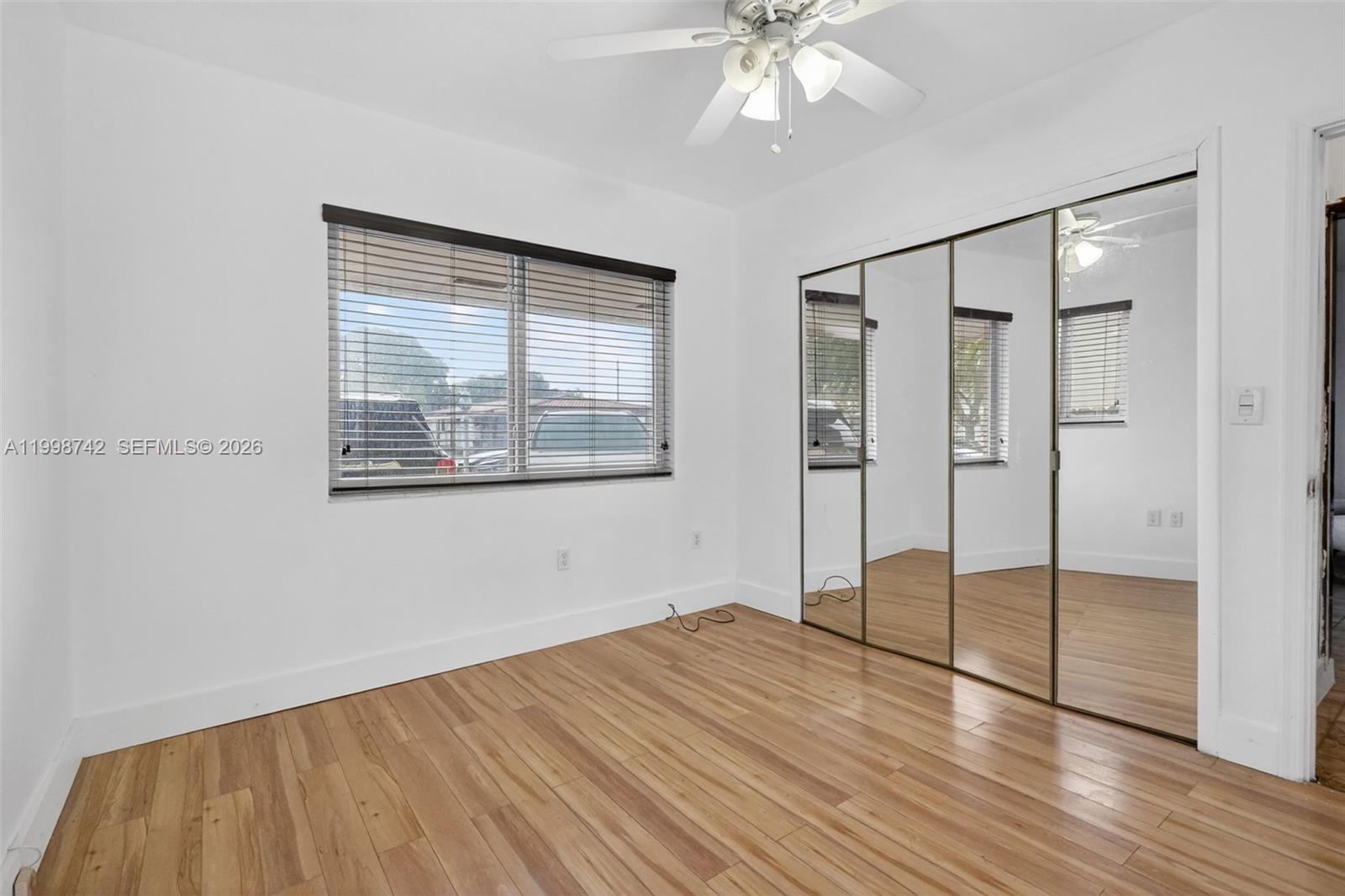 733 West 33rd Street Hialeah, FL 33012 - Photo 9 of 45 a view of empty room with wooden floor and fan