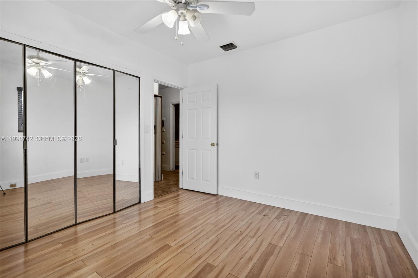 733 West 33rd Street Hialeah, FL 33012 - Photo 10 of 45 a view of an empty room with wooden floor