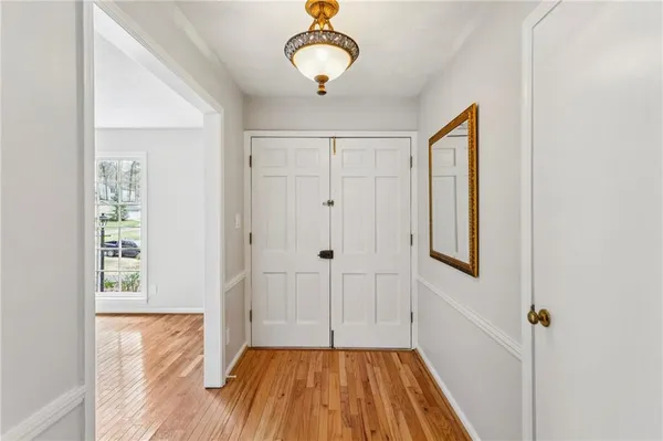 a view of a room with wooden floor closet and windows