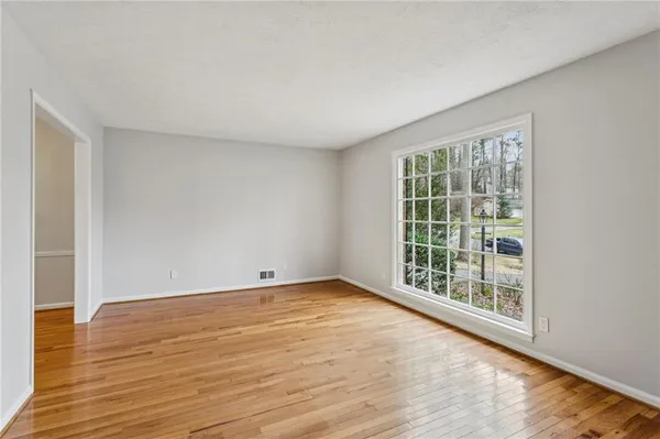 wooden floor in an empty room with a window