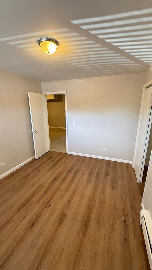 1119 East Algonquin Road, Unit 2 Arlington Heights, IL 60005 - Photo 21 of 30 a view of empty room with wooden floor