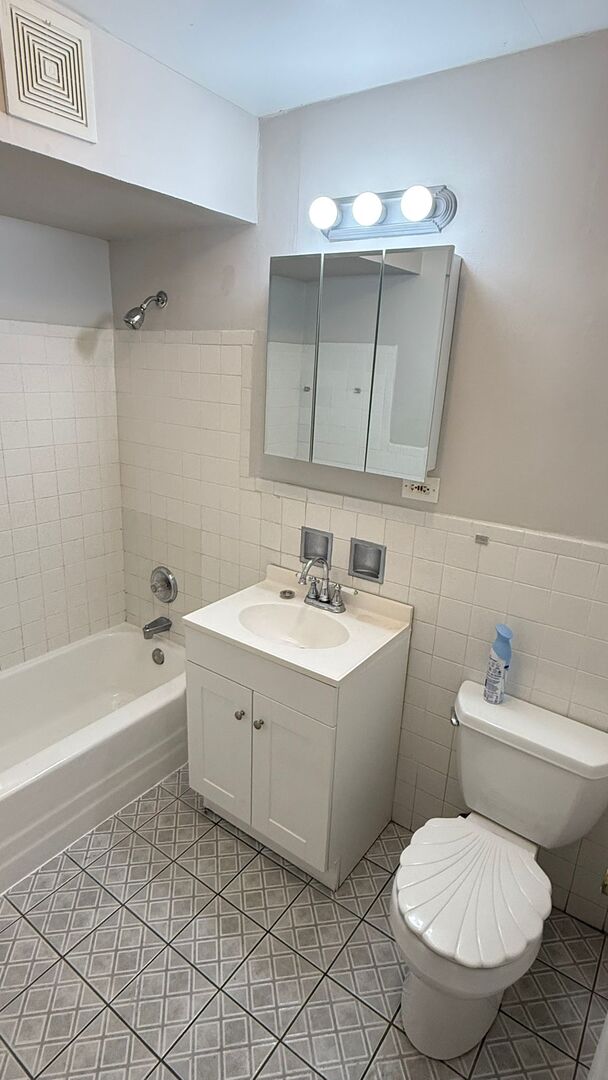1119 East Algonquin Road, Unit 2 Arlington Heights, IL 60005 - Photo 22 of 30 a bathroom with a sink toilet and shower