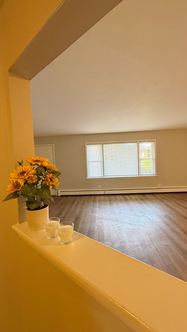 1119 East Algonquin Road, Unit 2 Arlington Heights, IL 60005 - Photo 24 of 30 a view of a room window and wooden floor