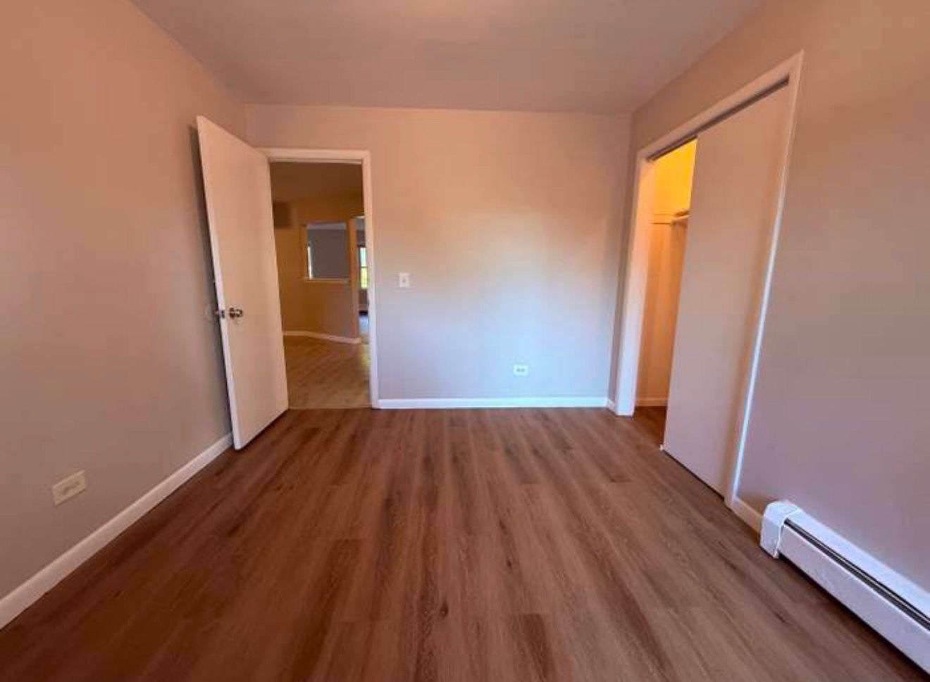 1119 East Algonquin Road, Unit 2 Arlington Heights, IL 60005 - Photo 6 of 30 an empty room with wooden floor and windows