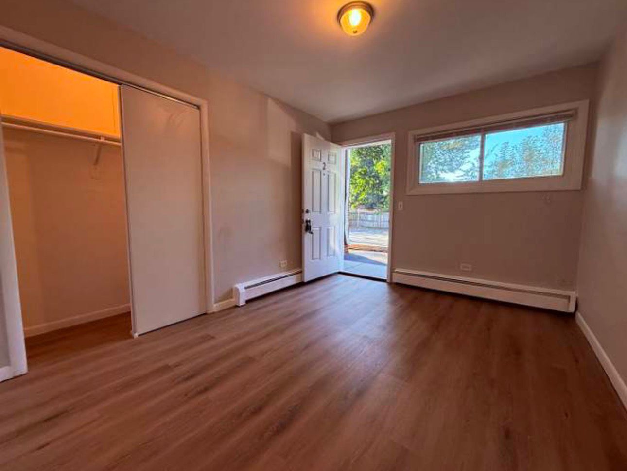 1119 East Algonquin Road, Unit 2 Arlington Heights, IL 60005 - Photo 7 of 30 an empty room with wooden floor and windows
