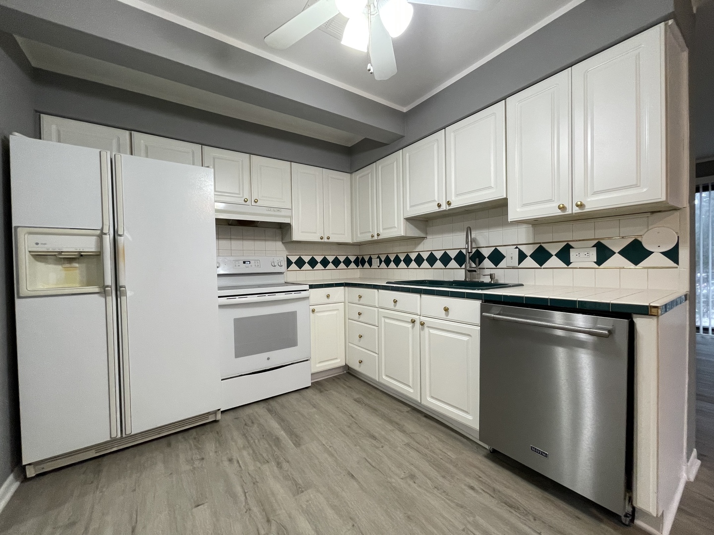 7533 SW Highway, Unit 2E Worth, IL 60482 - Photo 4 of 10 a kitchen with a white cabinets and white appliances