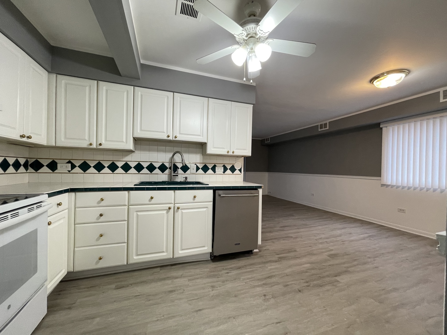 7533 SW Highway, Unit 2E Worth, IL 60482 - Photo 5 of 10 a kitchen with stainless steel appliances granite countertop a stove a sink and white cabinets