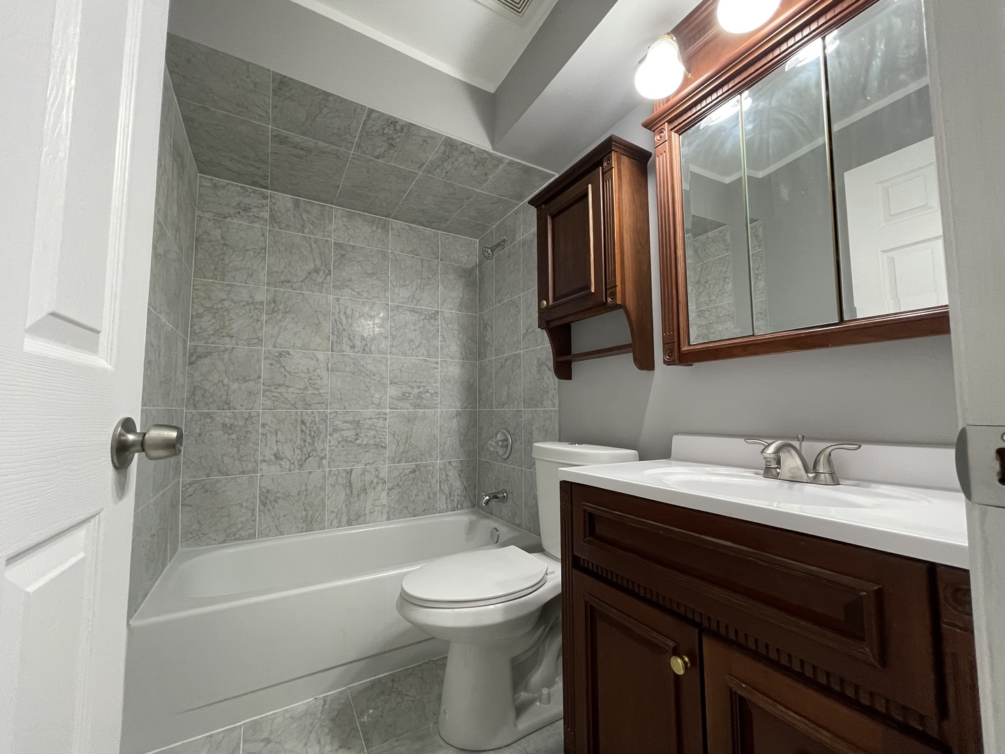 7533 SW Highway, Unit 2E Worth, IL 60482 - Photo 7 of 10 a bathroom with a sink a toilet and bathtub