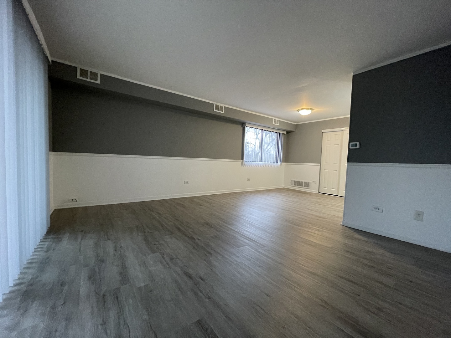 7533 SW Highway, Unit 2E Worth, IL 60482 - Photo 8 of 10 an empty room with wooden floor and windows