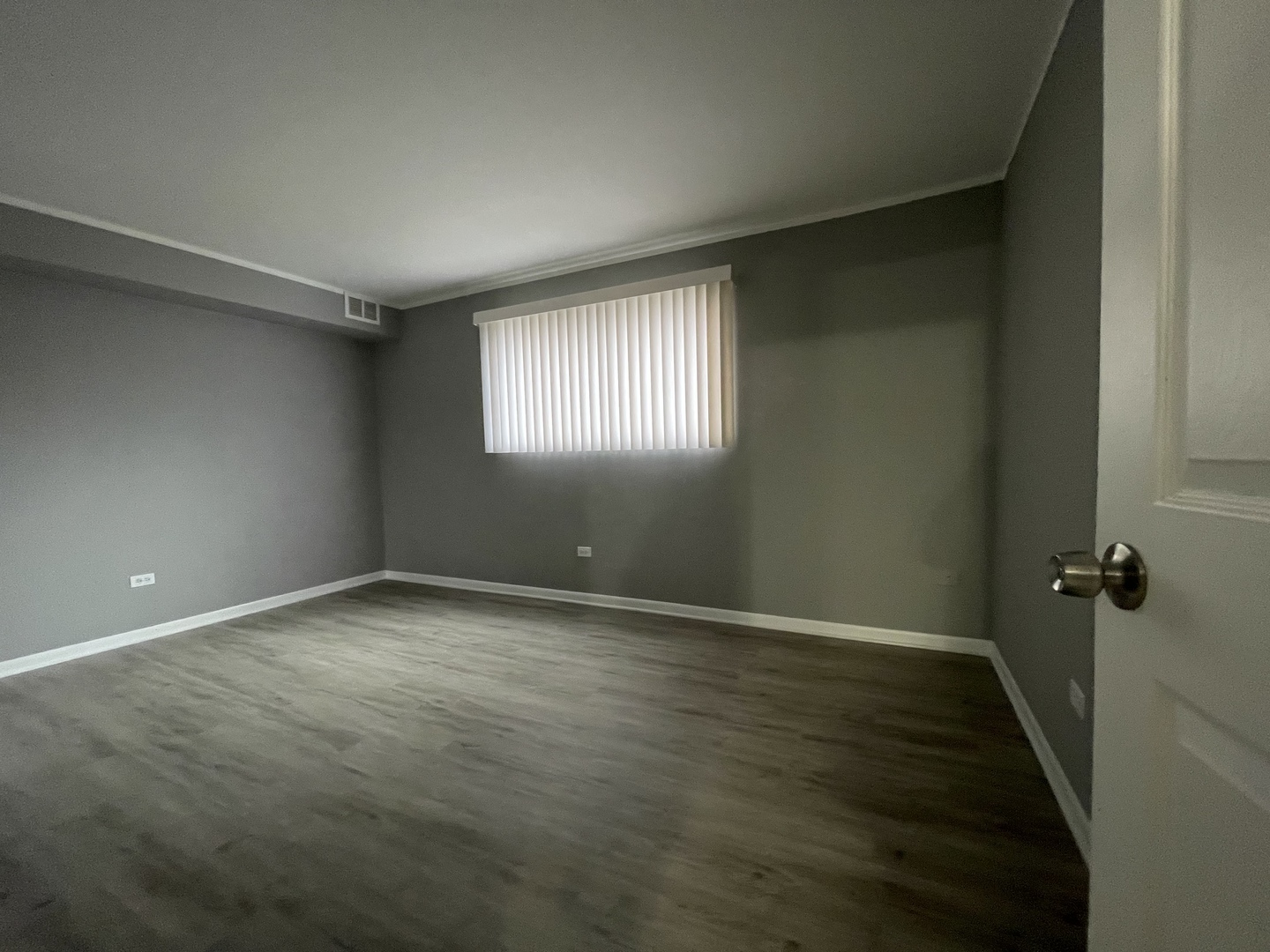 7533 SW Highway, Unit 2E Worth, IL 60482 - Photo 9 of 10 an empty room with wooden floor and windows