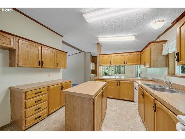 a kitchen that has a sink and a stove in it