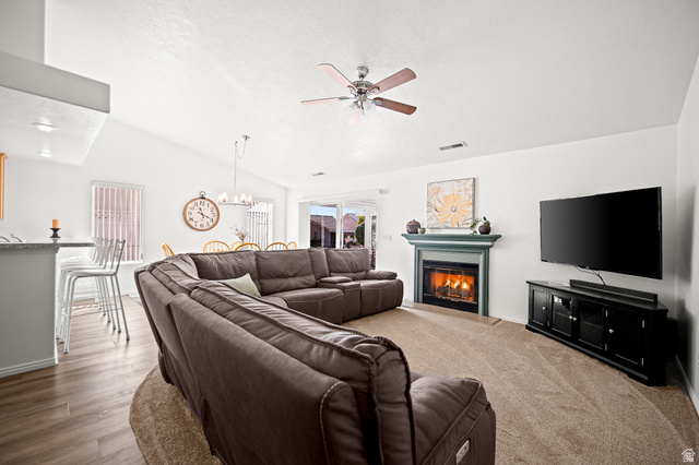 1825 West Mathis Park Place, Unit 46 St. George, UT 84770 - Photo 10 of 45 Living area with a ceiling fan, a glass covered fireplace, and a chandelier