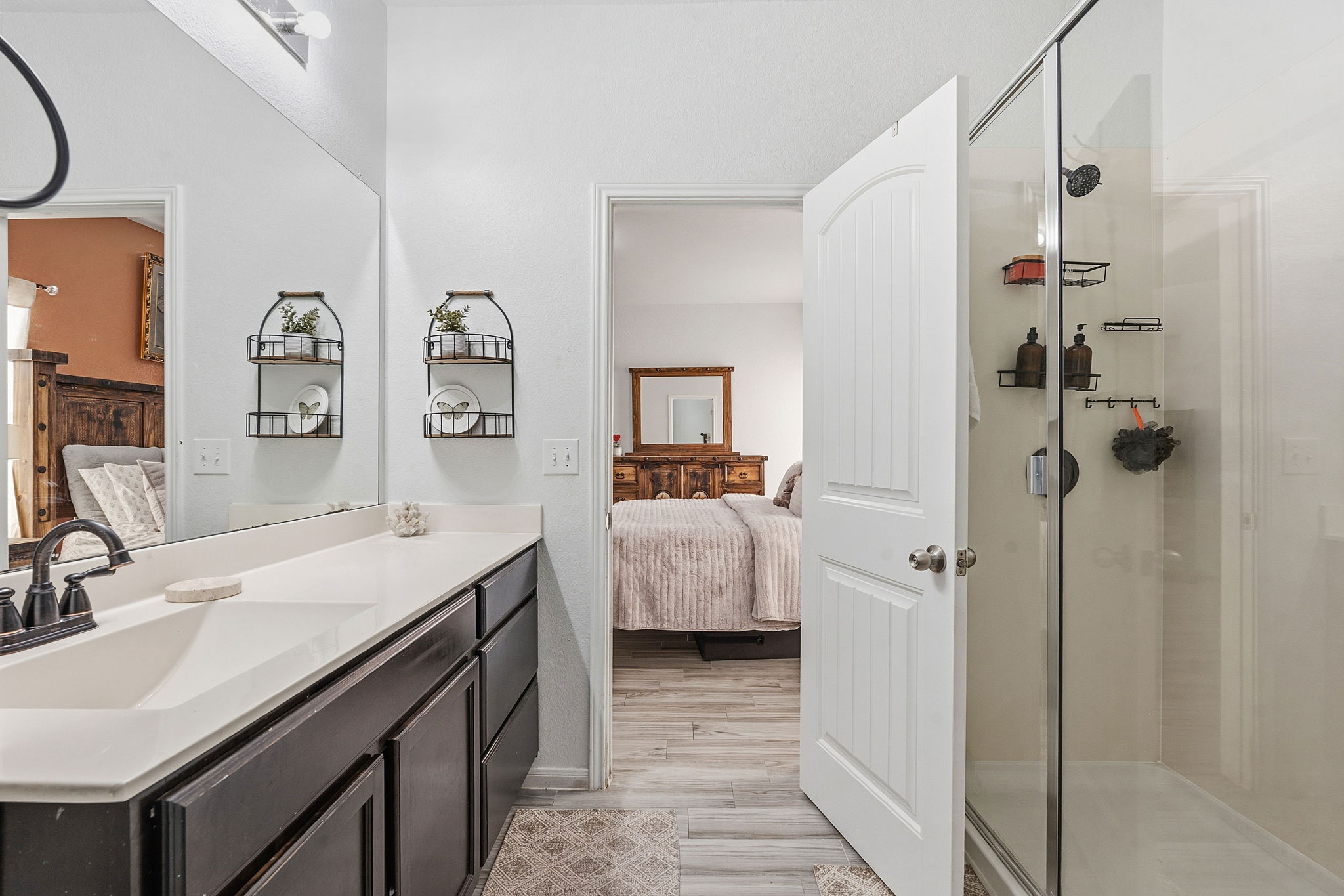 15101 Shell Bark Cove Austin, TX 78724 - Photo 15 of 26 Bathroom vanity featuring a single basin, light-colored countertop, and dark cabinetry