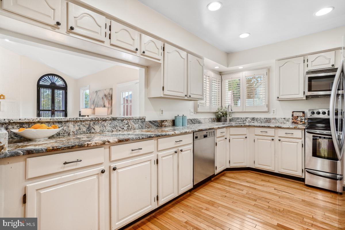10 Leatherleaf Court Gaithersburg, MD 20878 - Photo 15 of 47 a kitchen with granite countertop white cabinets and white appliances