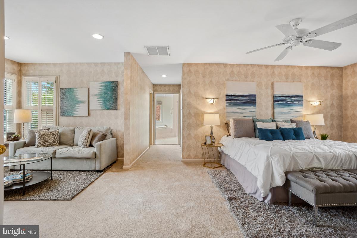 10 Leatherleaf Court Gaithersburg, MD 20878 - Photo 24 of 47 a spacious bedroom with a bed a couch and large window