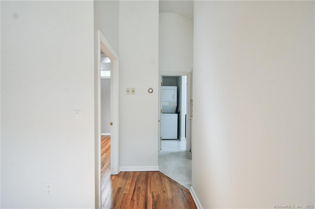 1500 Redding Road Fairfield, CT 06824 - Photo 17 of 22 View to separate bedroom on the left and back to washer/dryer and newly renovated full bath.