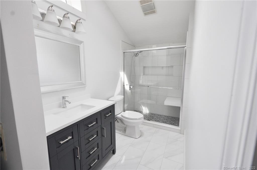 1500 Redding Road Fairfield, CT 06824 - Photo 21 of 22 Modern full bath features a vanity and spacious tiled stall shower.