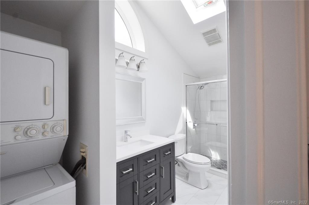 1500 Redding Road Fairfield, CT 06824 - Photo 22 of 22 The stacked washer/dryer units are just outside the full bath.