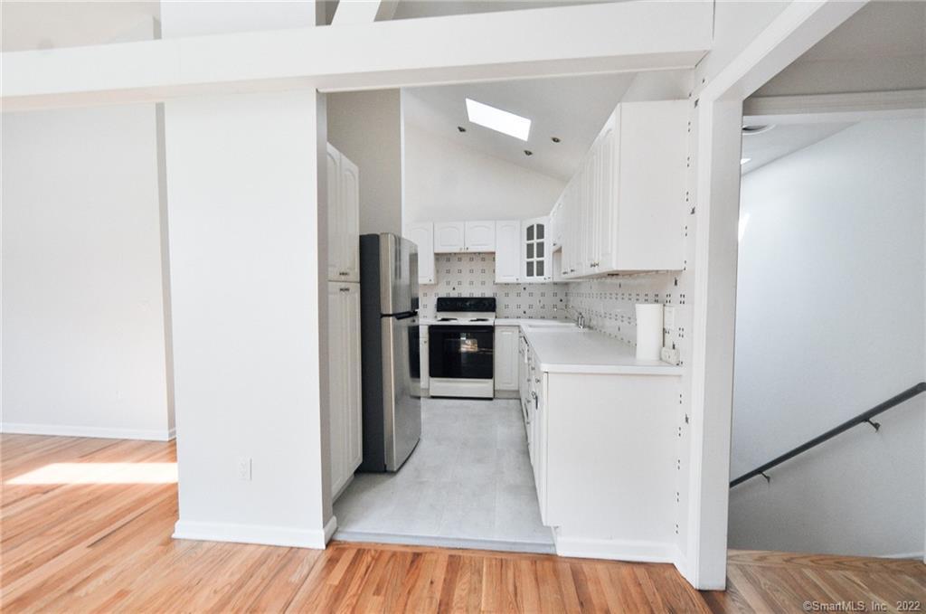 1500 Redding Road Fairfield, CT 06824 - Photo 9 of 22 L-shaped kitchen offers a spacious pantry, loads of counter prep space, storage, new refrigerator, new stove, dishwasher and new flooring.