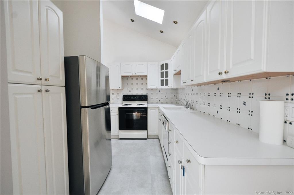 1500 Redding Road Fairfield, CT 06824 - Photo 10 of 22 The tall ceilings and skylight keep the kitchen light and bright!