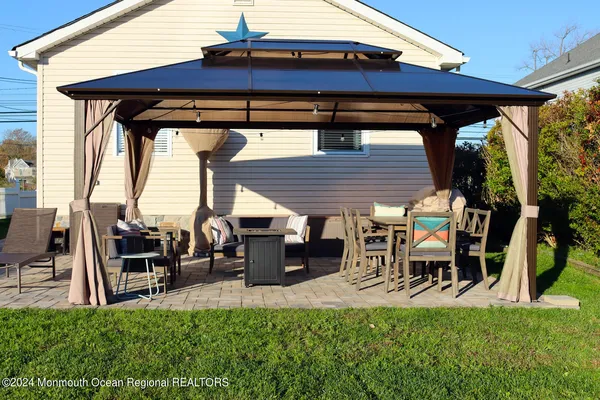 a view of a patio with table and chairs and potted plants