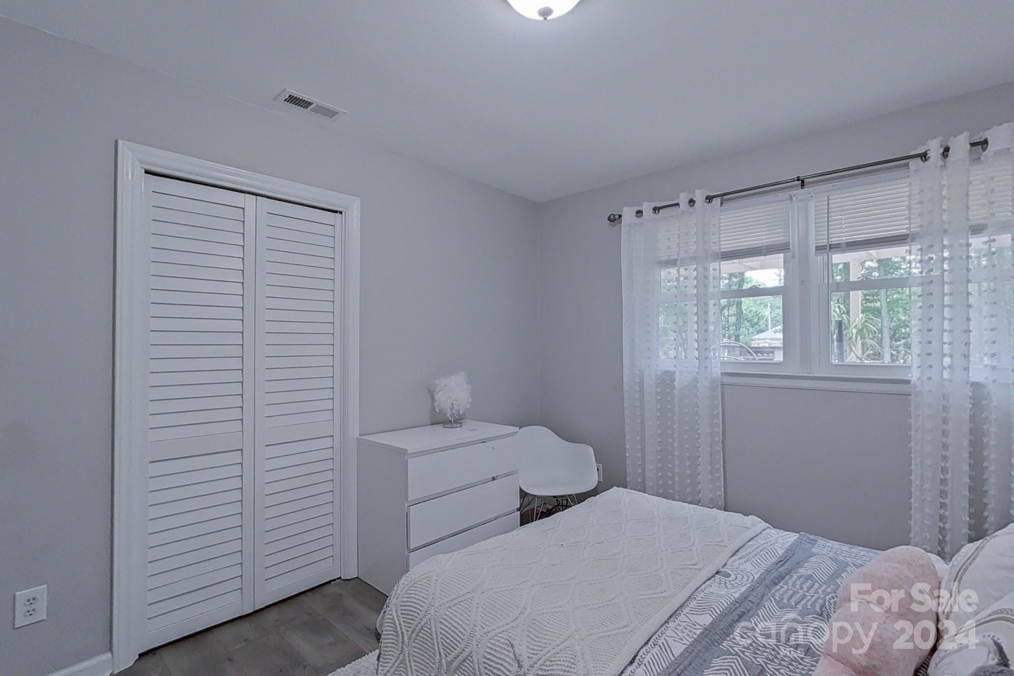 202 Smith Street Locust, NC 28097 - Photo 17 of 42 a bedroom with a bed and a window
