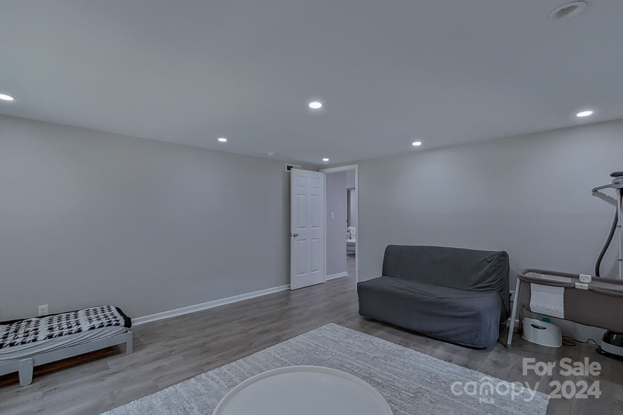 202 Smith Street Locust, NC 28097 - Photo 20 of 42 a living room with furniture and a rug