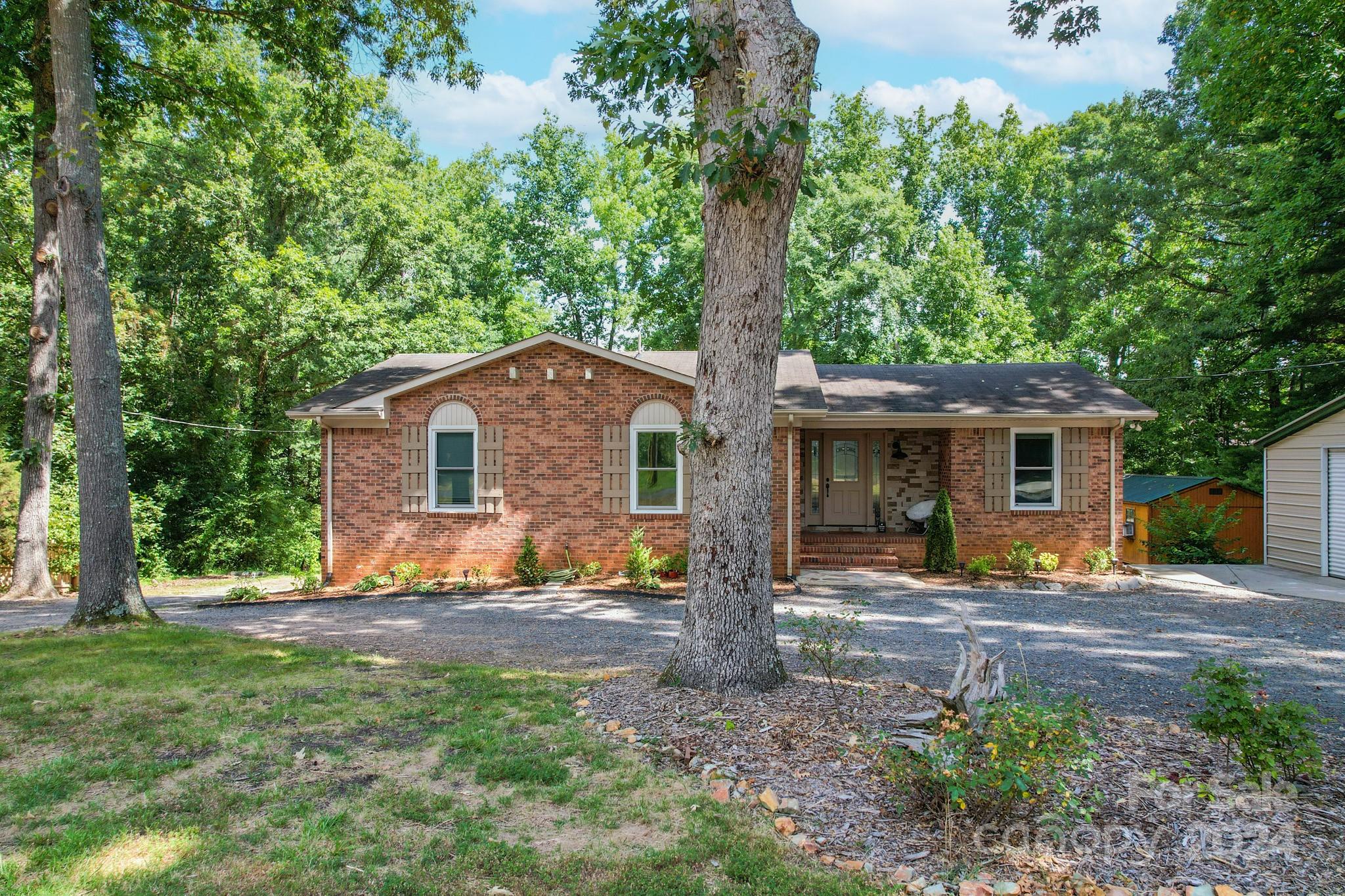 202 Smith Street Locust, NC 28097 - Photo 2 of 42 a backyard of a house with table and chairs