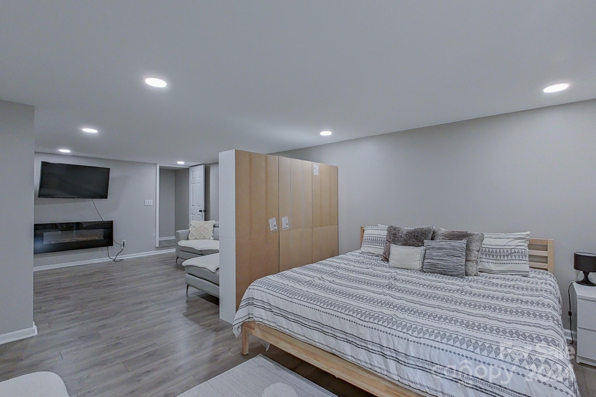 202 Smith Street Locust, NC 28097 - Photo 23 of 42 a bedroom with a bed and a television