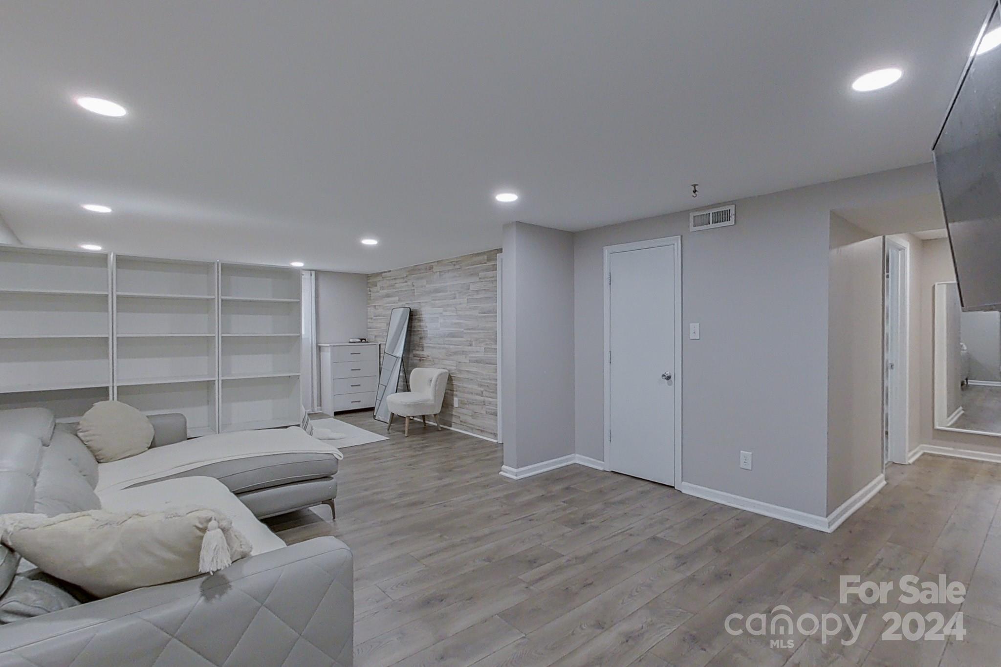 202 Smith Street Locust, NC 28097 - Photo 25 of 42 a living room with furniture and a wooden floor
