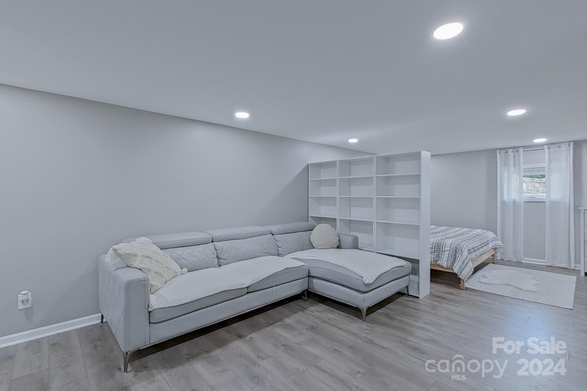 202 Smith Street Locust, NC 28097 - Photo 26 of 42 a living room with furniture and a wooden floor