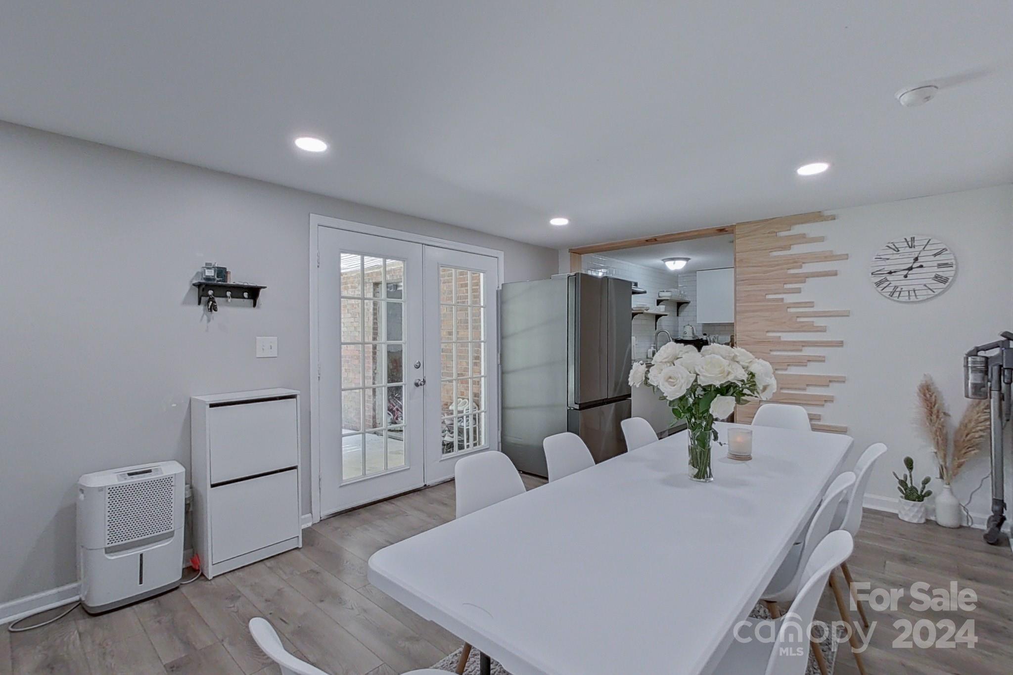 202 Smith Street Locust, NC 28097 - Photo 27 of 42 a dining room with furniture and a refrigerator