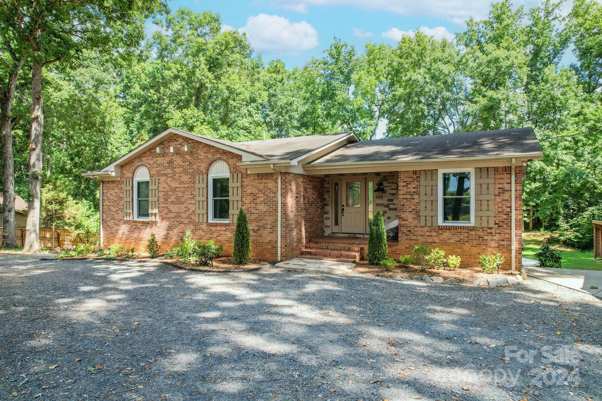202 Smith Street Locust, NC 28097 - Photo 3 of 42 a front view of a house with garden