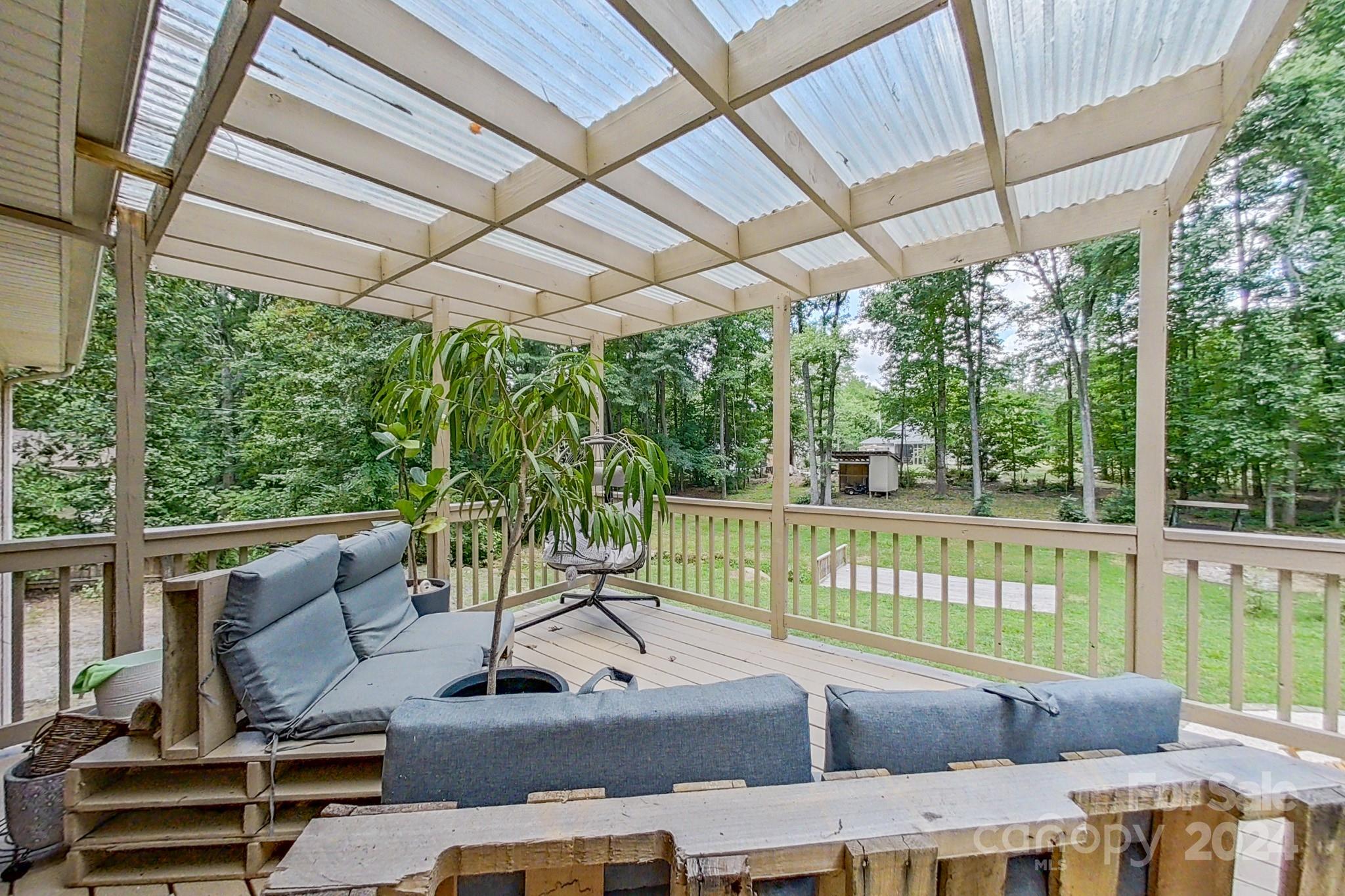 202 Smith Street Locust, NC 28097 - Photo 35 of 42 a view of a patio with couches table and chairs and potted plants