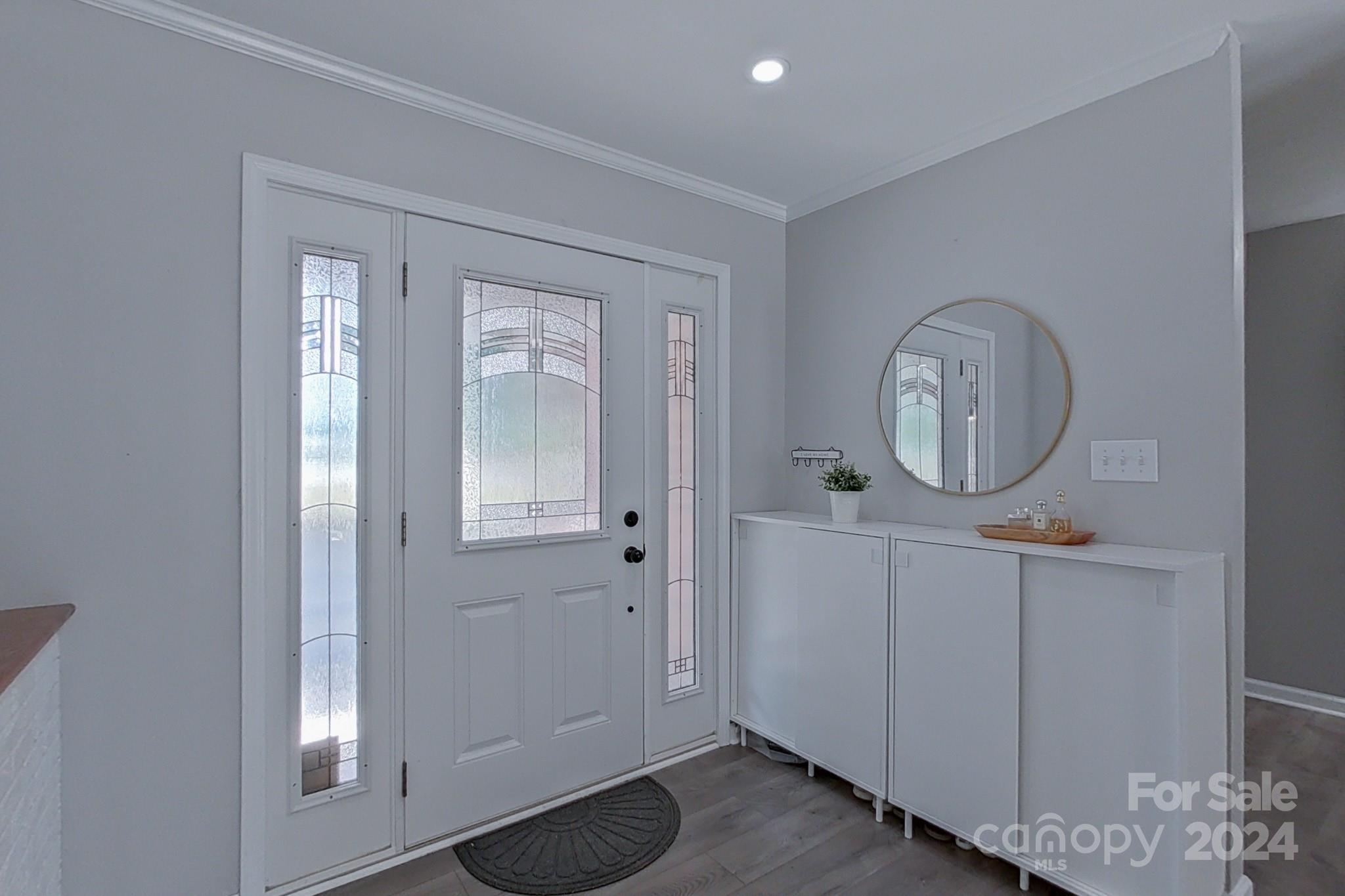 202 Smith Street Locust, NC 28097 - Photo 4 of 42 a view of a hallway with front door wooden floor and cabinet