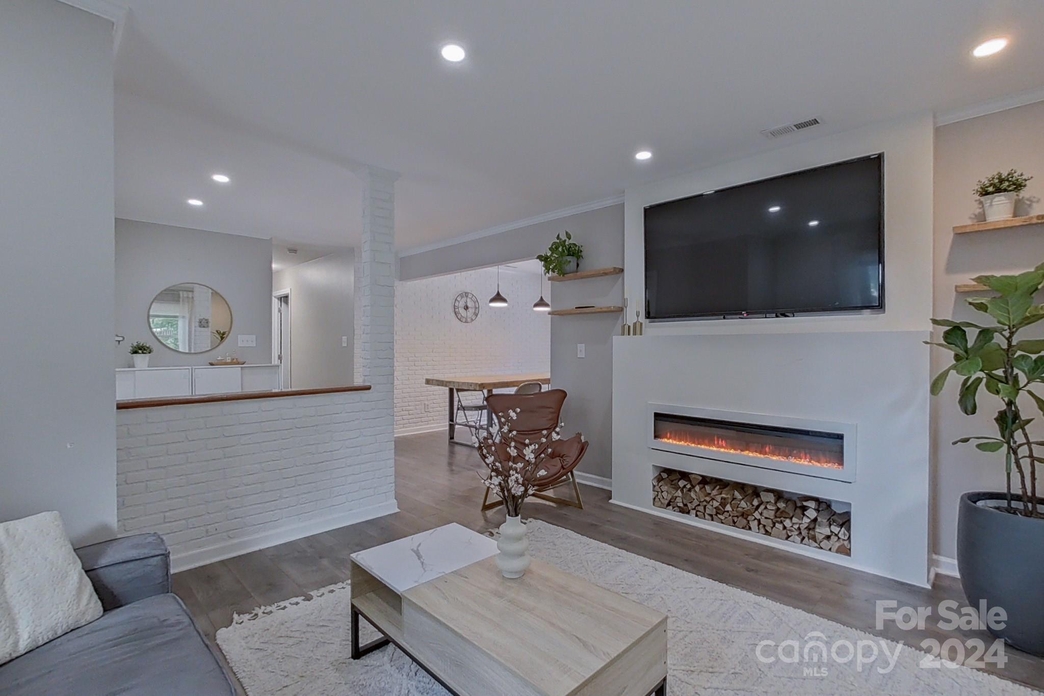 202 Smith Street Locust, NC 28097 - Photo 7 of 42 a living room with furniture and a flat screen tv